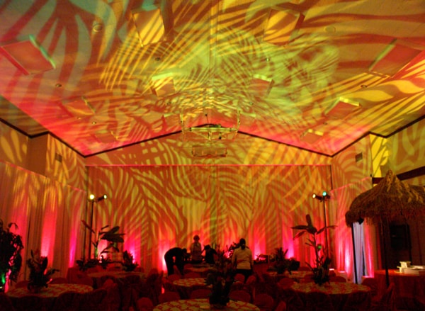 Tropical event with lush pink and gold production design