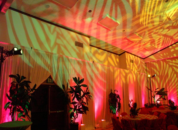 Tropical themed event with pink and gold lighting effects